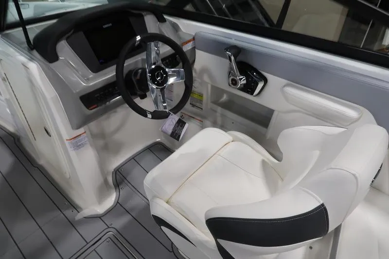 Slide: The Image of 2025 Chaparral 23 SSi boat interior with steering wheel and captain's seat. - 23