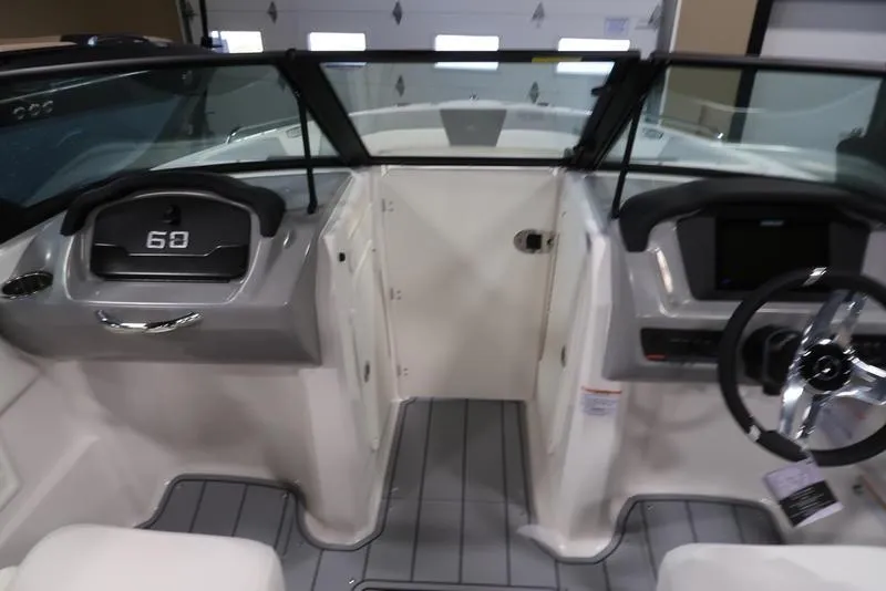Slide: The Image of 2025 Chaparral 23 SSi boat interior with modern dashboard and steering wheel. - 25