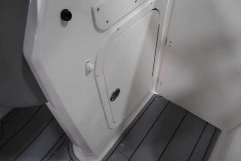 Slide: The Image of 2025 Chaparral 23 SSi boat interior with sleek white panel and gray flooring. - 27
