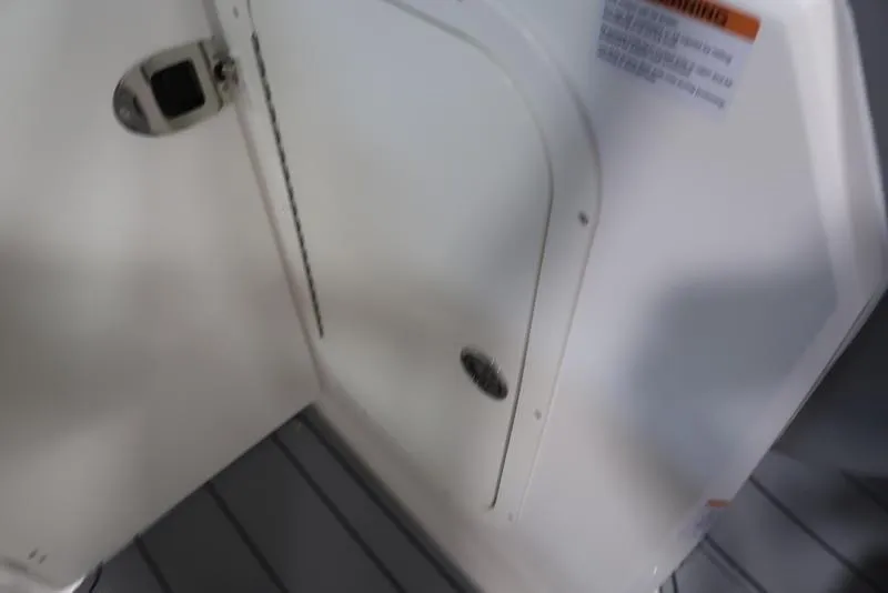 Slide: The Image of 2025 Chaparral 23 SSi boat interior, featuring a white cabin door and sleek design. - 29