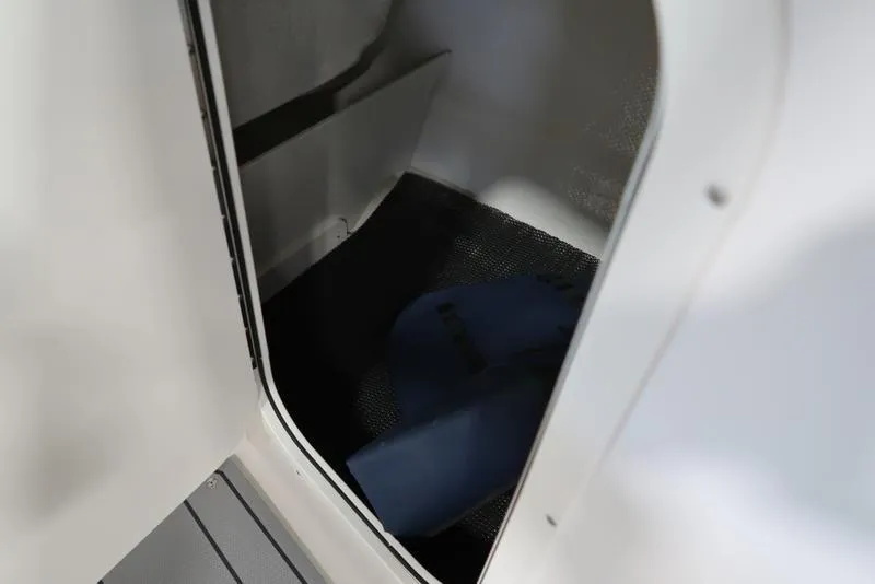 Slide: The Image of Interior storage compartment of 2025 Chaparral 23 SSi boat. - 30