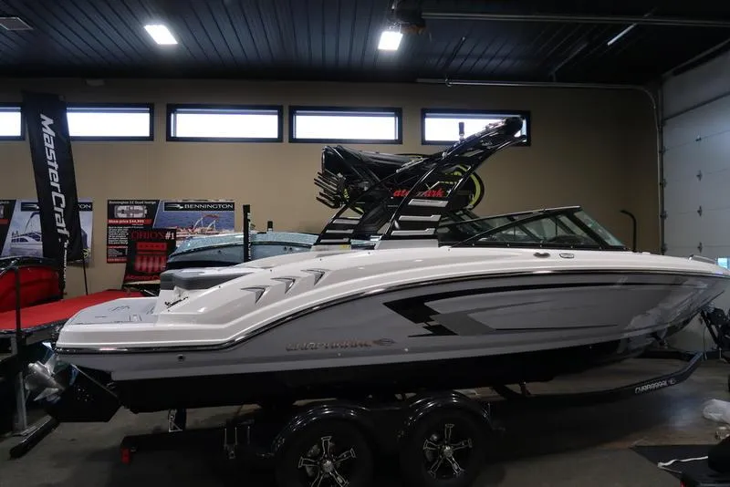 Slide: The Image of 2025 Chaparral 23 SSi boat displayed indoors on a trailer. - 4