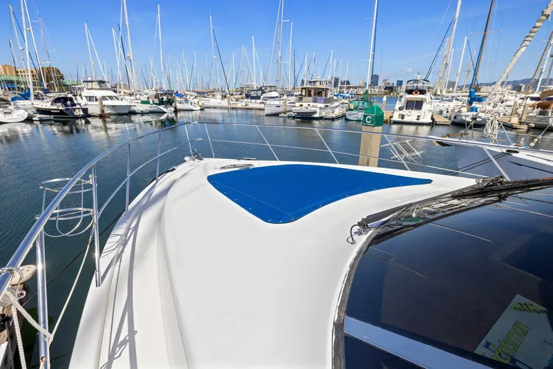 Slide: The Image of 2008 Dyna 51 yacht docked in a marina with numerous sailboats. - 15