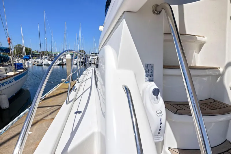 Slide: The Image of 2008 Dyna 51 yacht deck with EPIRB, docked at marina with sailboats. - 16