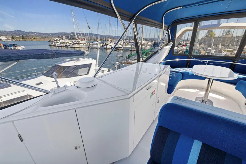 Slide: The Image of Luxurious 2008 Dyna 51 yacht interior with marina view, featuring seating and kitchenette. - 20