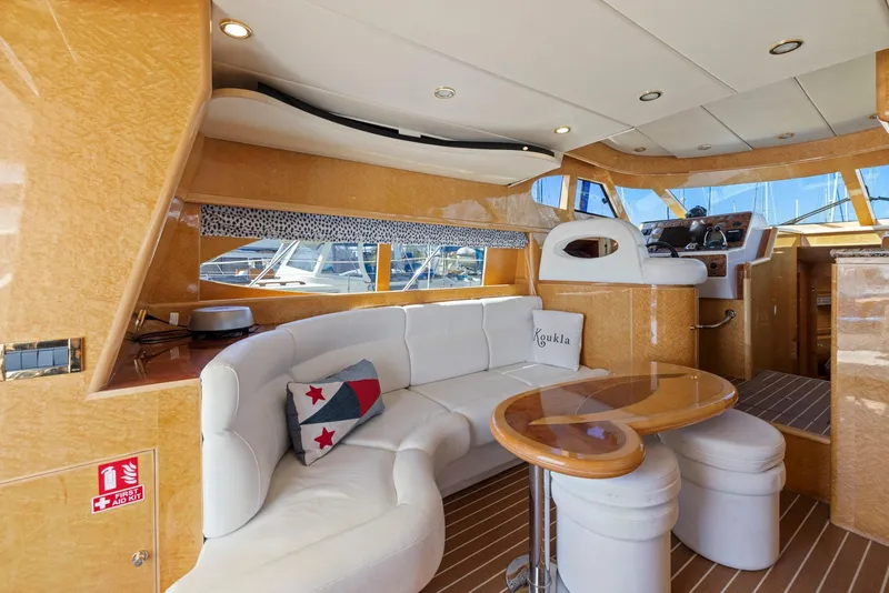 Slide: The Image of Luxurious 2008 Dyna 51 yacht interior with white seating, wooden accents, and a modern helm. - 24