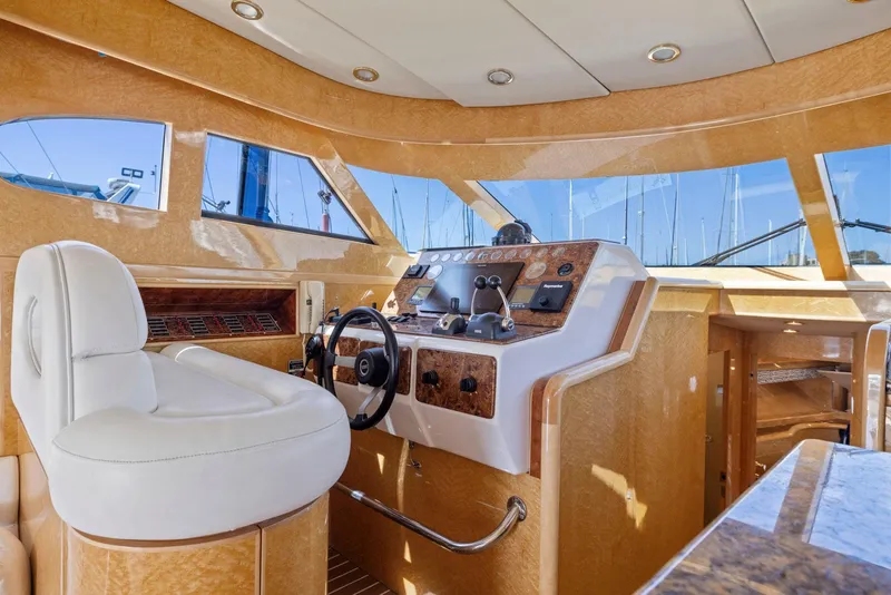 Slide: The Image of Luxurious 2008 Dyna 51 yacht helm with plush seating and modern controls. - 26
