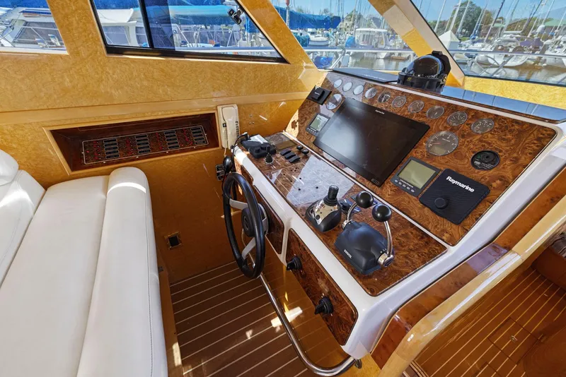 Slide: The Image of Luxurious 2008 Dyna 51 yacht helm with wood accents and modern navigation equipment. - 28