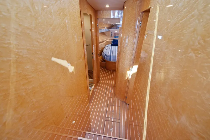 Slide: The Image of Luxurious interior of 2008 Dyna 51 yacht with wood paneling and striped bedding. - 35