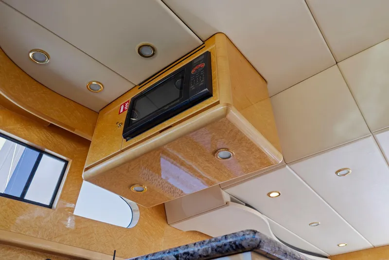 Slide: The Image of 2008 Dyna 51 yacht interior with built-in microwave and modern ceiling design. - 37