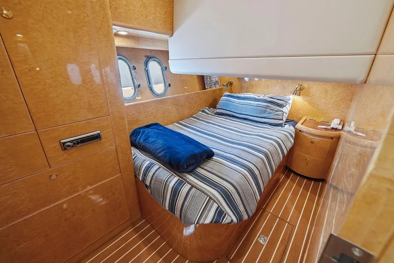 Slide: The Image of Luxurious cabin interior of 2008 Dyna 51 yacht with striped bedding and wooden finishes. - 39
