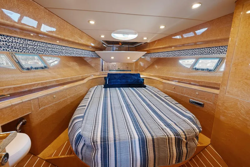 Slide: The Image of Luxurious 2008 Dyna 51 yacht cabin with striped bedding and elegant wood finish. - 41