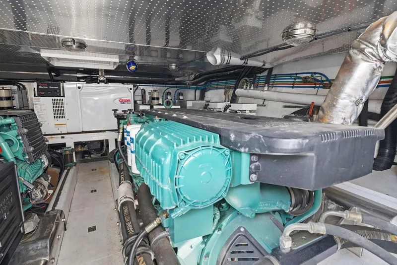 Slide: The Image of Engine room of a 2008 Dyna 51 yacht, featuring mechanical components and wiring. - 46