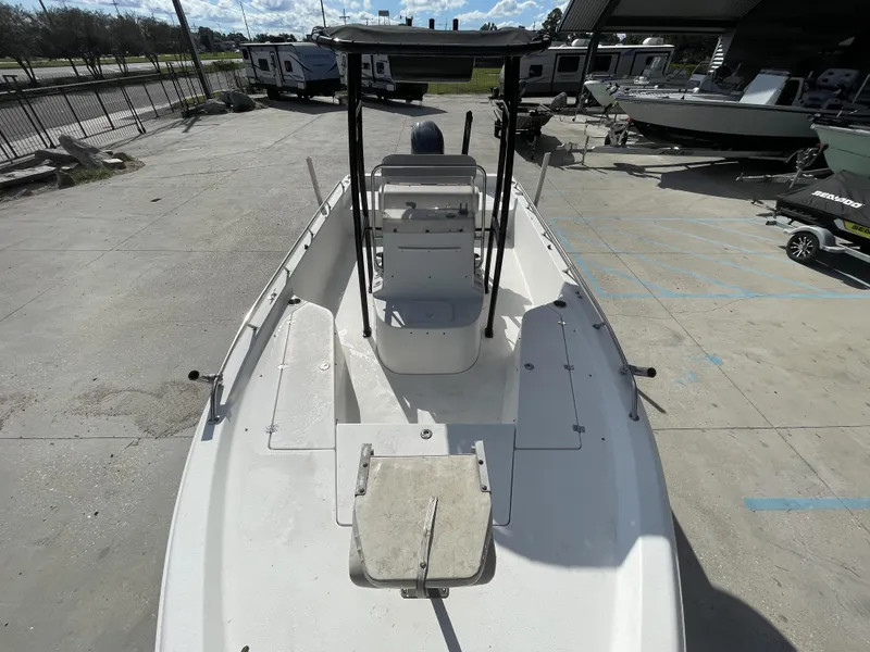 Slide: The Image of 2005 Sea Pro SV2100 boat, white deck, center console, parked outdoors. - 10