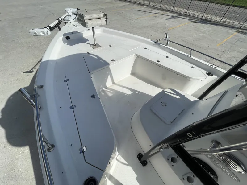 Slide: The Image of 2005 Sea Pro SV2100 boat deck with trolling motor and storage compartments. - 11