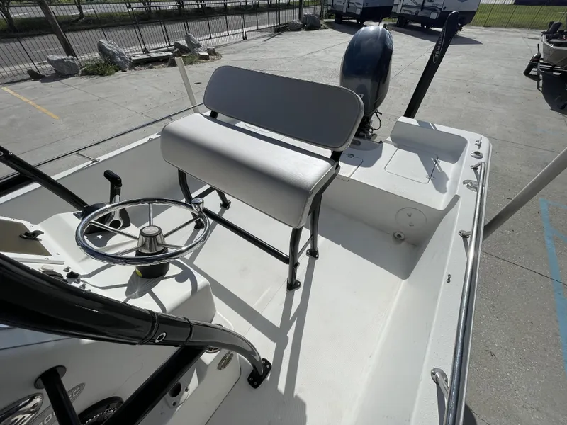 Slide: The Image of 2005 Sea Pro SV2100 boat interior with steering wheel and seating. - 13