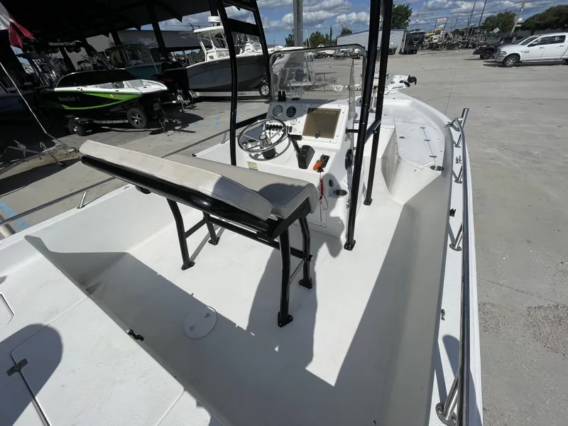 Slide: The Image of 2005 Sea Pro SV2100 boat interior with console and seating, parked in a marina. - 17