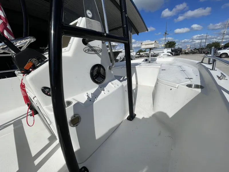 Slide: The Image of 2005 Sea Pro SV2100 boat interior with console and seating, under a clear blue sky. - 18
