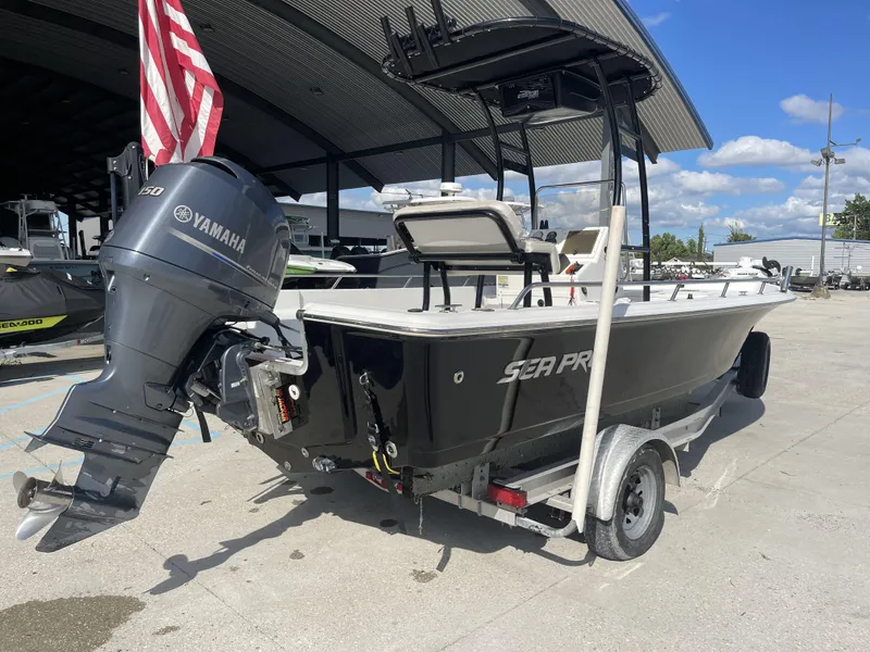 Slide: The Image of 2005 Sea Pro SV2100 boat with Yamaha engine on trailer, parked outdoors. - 3
