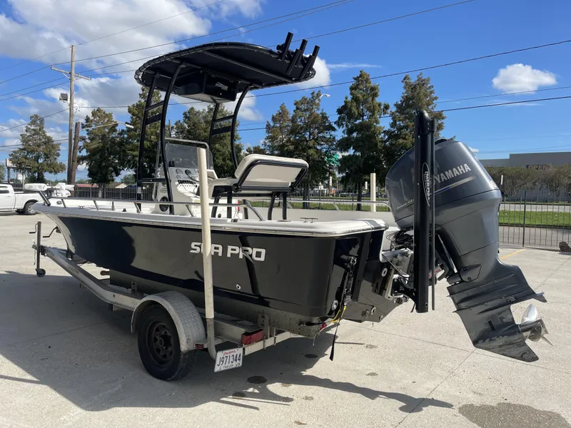 Slide: The Image of 2005 Sea Pro SV2100 boat on trailer with Yamaha outboard motor, parked outdoors. - 5