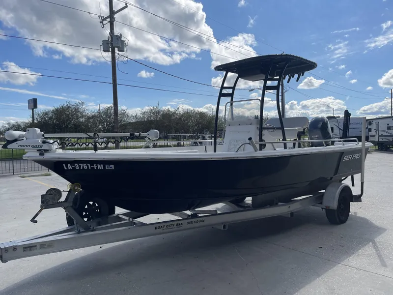 Slide: The Image of 2005 Sea Pro SV2100 boat on trailer, parked outdoors under a blue sky. - 7