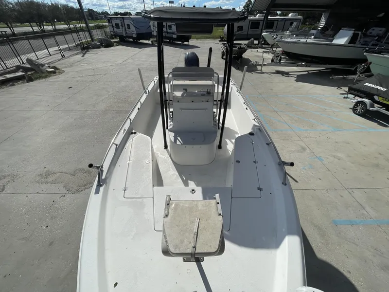 Slide: The Image of 2005 Sea Pro SV2100 boat, white deck, parked outdoors, with T-top and console. - 9
