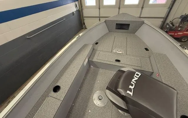 Slide: The Image of 2025 Lund 1600 Fury Tiller boat interior, featuring spacious seating and storage compartments. - 7