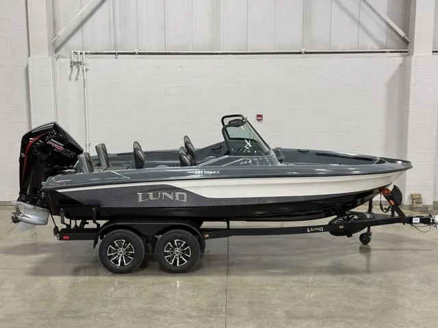 Slide: The Image of 2025 Lund 185 Impact GL Sport boat on trailer, displayed indoors. - 1