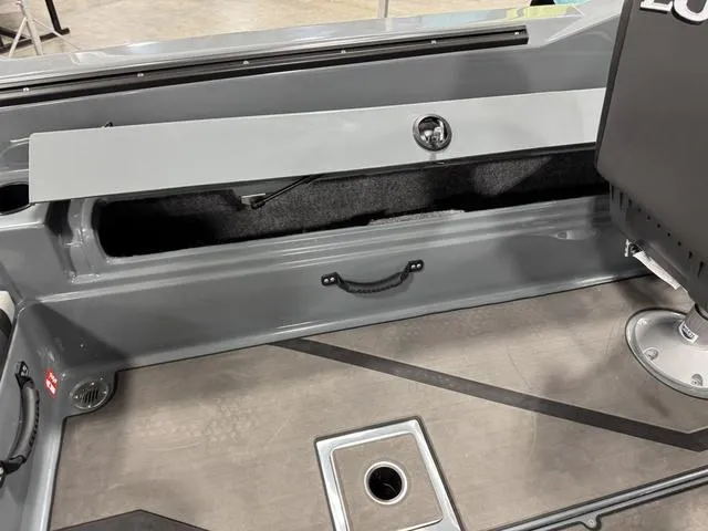 Slide: The Image of 2025 Lund 185 Impact GL Sport boat interior with storage compartment and seating. - 13