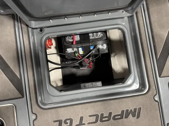 Slide: The Image of Battery compartment of 2025 Lund 185 Impact GL Sport boat, showcasing wiring and connections. - 16