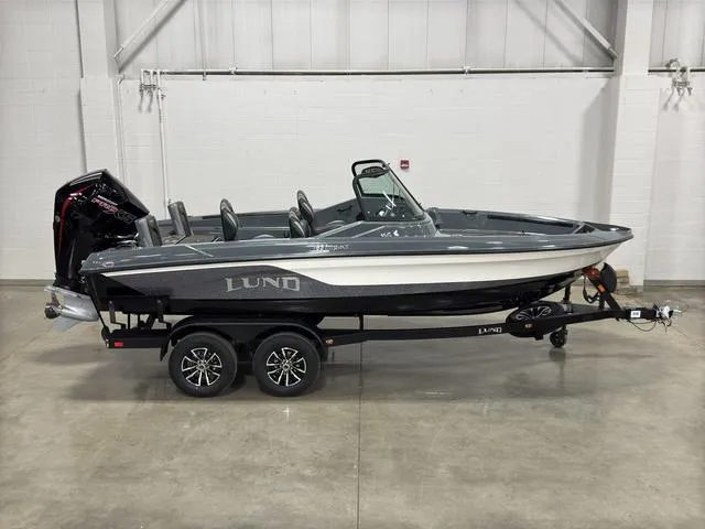 Slide: The Image of 2025 Lund 185 Impact GL Sport boat on trailer in indoor showroom. - 2