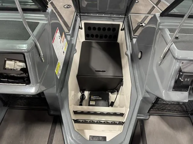 Slide: The Image of 2025 Lund 185 Impact GL Sport boat interior with storage compartment and precision equipment. - 21