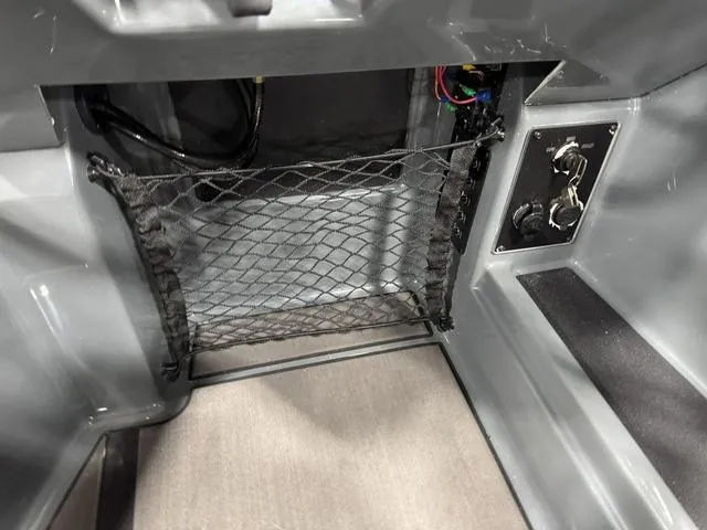 Slide: The Image of 2025 Lund 185 Impact GL Sport interior storage with netting and control panel. - 25