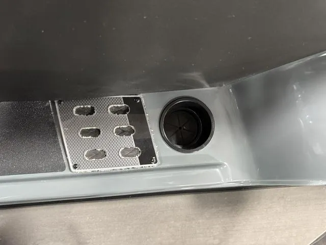 Slide: The Image of Interior detail of 2025 Lund 185 Impact GL Sport boat, featuring a cup holder and footrest. - 28