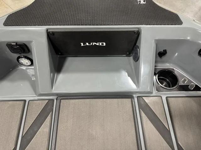 Slide: The Image of 2025 Lund 185 Impact GL Sport boat interior with storage and cup holder. - 29