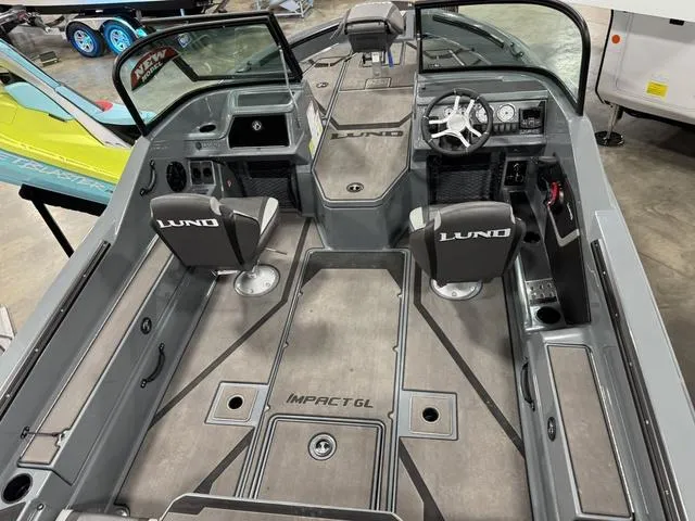 Slide: The Image of 2025 Lund 185 Impact GL Sport boat interior with dual seats and steering console. - 3