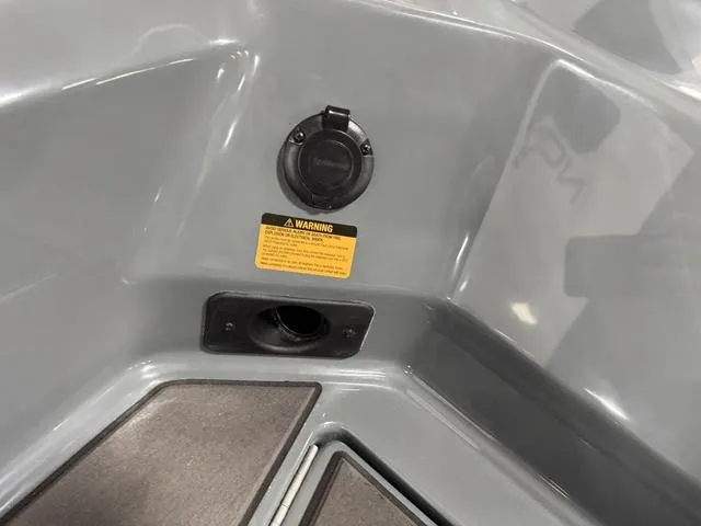 Slide: The Image of 2025 Lund 185 Impact GL Sport boat interior with warning label and socket detail. - 32