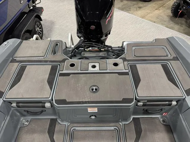 Slide: The Image of 2025 Lund 185 Impact GL Sport boat deck with storage compartments and motor. - 4