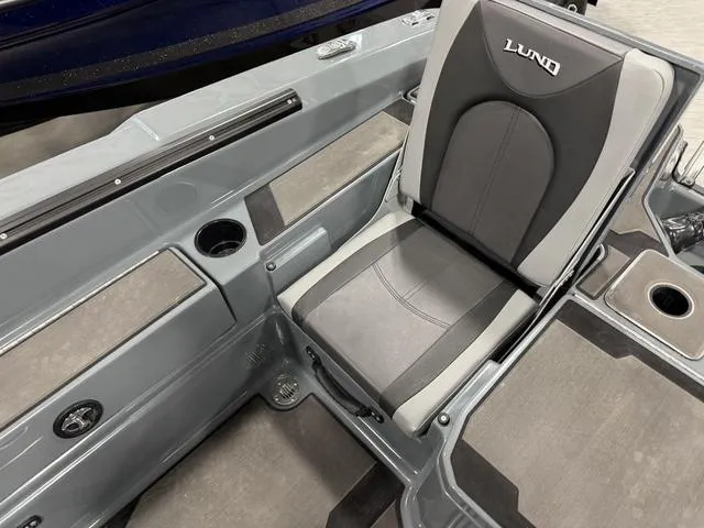 Slide: The Image of 2025 Lund 185 Impact GL Sport boat interior with gray seating and cup holders. - 8