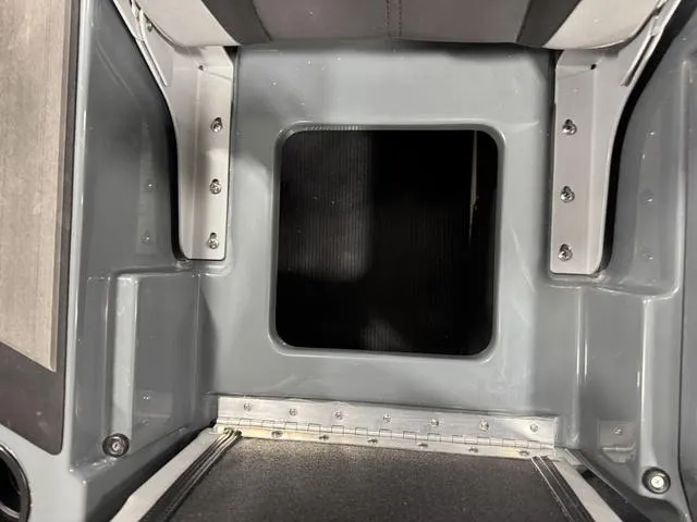Slide: The Image of 2025 Lund 185 Impact GL Sport boat interior, featuring a storage compartment with sleek gray finish. - 9
