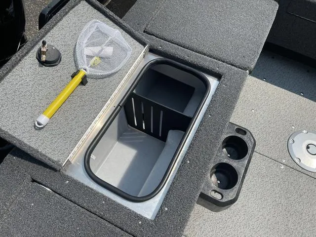 Slide: The Image of 2025 Lund 1775 Adventure Sport boat storage compartment with fishing net and cup holders. - 10