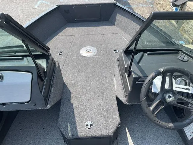 Slide: The Image of 2025 Lund 1775 Adventure Sport boat interior with steering wheel and spacious deck layout. - 13