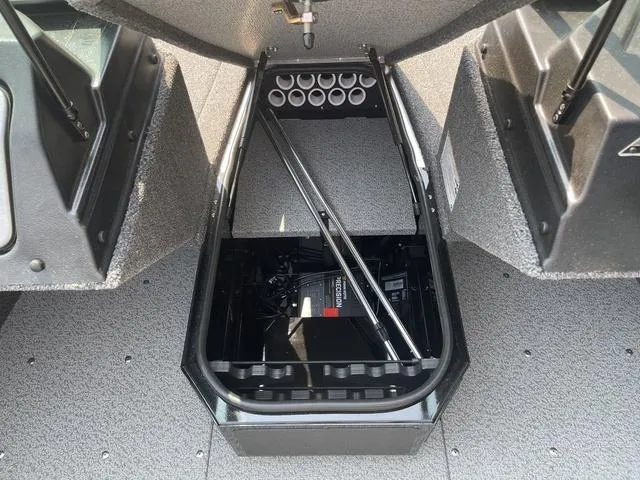 Slide: The Image of Interior storage compartment of 2025 Lund 1775 Adventure Sport boat, featuring organized rod holders. - 14