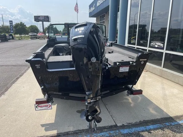 Slide: The Image of 2025 Lund 1775 Adventure Sport boat with outboard motor, parked outside a dealership. - 3