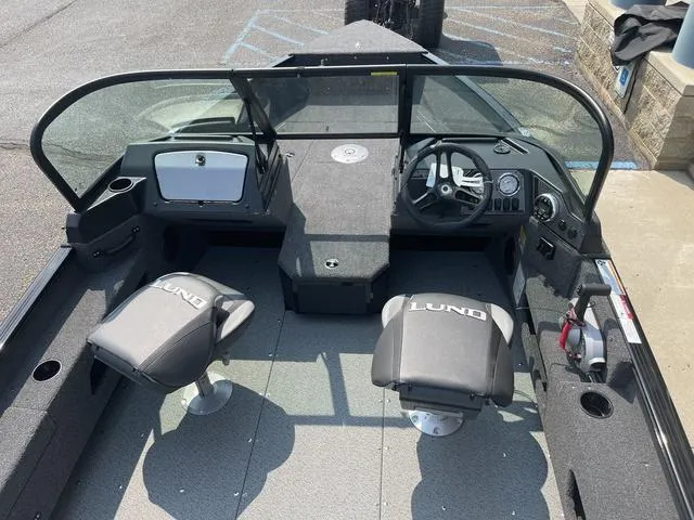 Slide: The Image of 2025 Lund 1775 Adventure Sport boat interior with dual seats and steering console. - 5