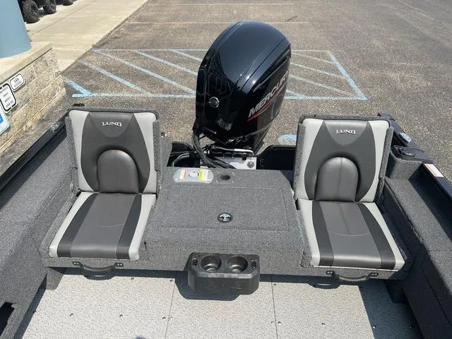 Slide: The Image of 2025 Lund 1775 Adventure Sport boat interior with Mercury engine, featuring two gray seats. - 9