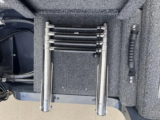 Slide: The Image of 2025 Lund 1775 Adventure Sport boat ladder and handle on carpeted deck. - 7