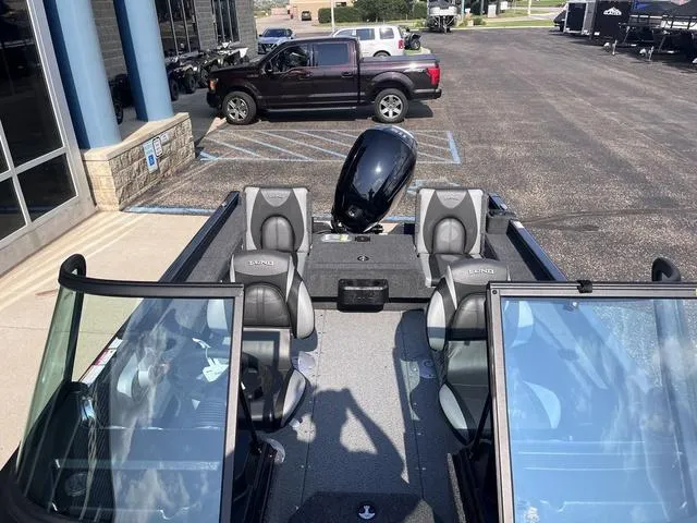 Slide: The Image of 2025 Lund 1775 Adventure Sport boat with seating, parked near a building. - 9