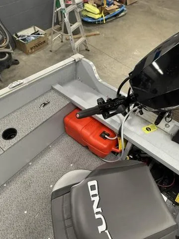 Slide: The Image of 2025 Lund 1600 Fury Tiller boat interior with motor and fuel tank. - 10