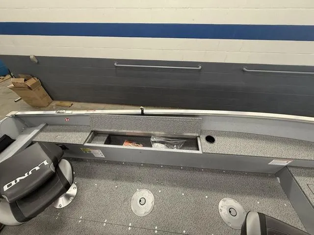 Slide: The Image of 2025 Lund 1600 Fury Tiller boat interior with storage compartment and seating. - 14